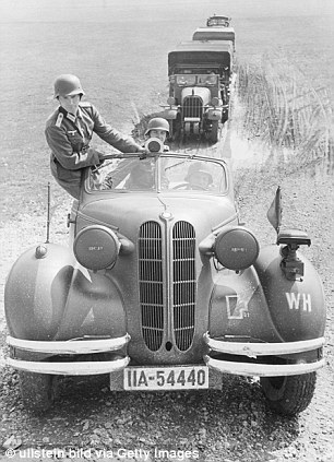 German soldiers in a requisitioned BMW 327 cabrio